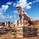 A stone lion statue in an arid coastal environment